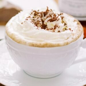 Latte beverage with whipped cream and chocolate shavings from Casa Bake.